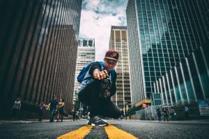 photo of man taking photo on a street